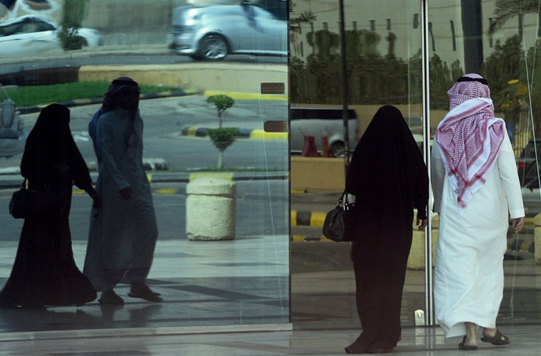 A Saudi couple enters a shopping mall in the capital Riyadh on Oct. 26, as Saudi women scrapped a