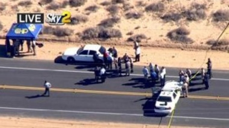 A homicide suspect was killed by police on this Mojave Desert highway early Friday after a lengthy pursuit in which the man fired at vehicles and two hostages in his car trunk, authorities said.