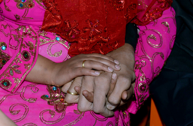 The World's tallest man Sultan Kosen and his fiancee Merve Dibo hold hands during their henna night, the ceremony held one day before the wedding, on Oct. 26, 2013 in the Dede village of Mardin, Turkey.