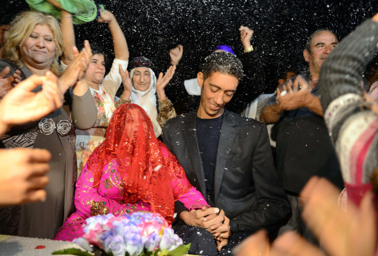 The World's tallest man Sultan Kosen and his fiancee Merve Dibo during their henna night, the ceremony held one day before the wedding, on Oct. 26, 2013 in the Dede village of Mardin, Turkey.