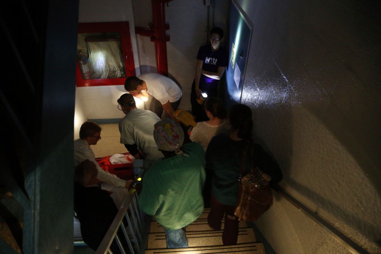 Hospital workers help a patient as they evacuate the NYU Langone Medical Center during Superstorm Sandy on Oct. 29, 2012.