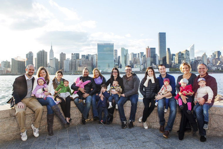 Six families with their babies from Superstorm Sandy pose for a portrait Sunday at Gantry Plaza State Park in Queens, N.Y.