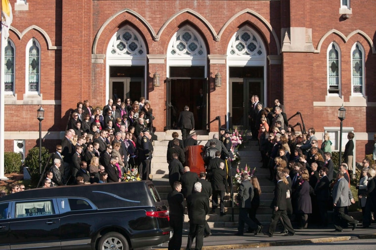 Mourners pay their respects as the casket bearing slain teacher Colleen Ritzer arrives at St. Augustine's Parish in Andover, Massachusetts.