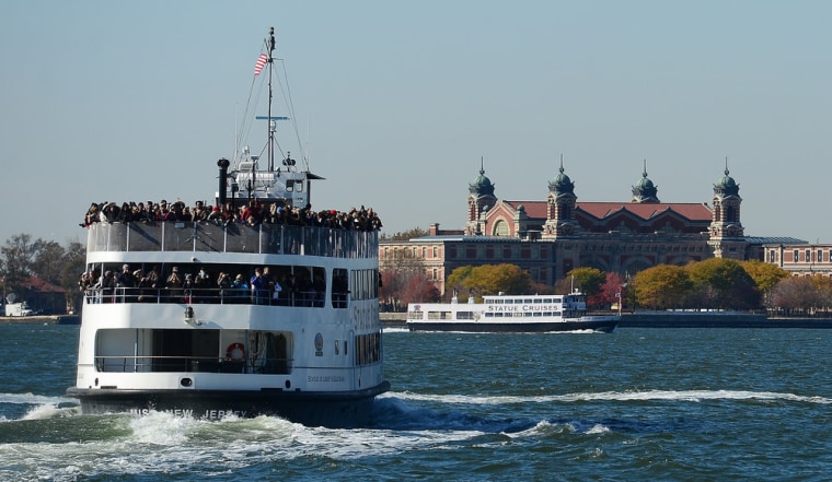 A ferry carrying visitors makes its way to Ellis Island, the island that ushered millions of immigrants into the United States, as it reopens Monday to visitors the first time since Superstorm Sandy.