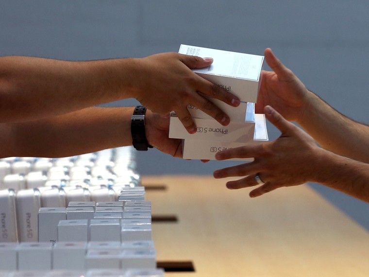 PALO ALTO, CA - SEPTEMBER 20: Apple Store employees pass boxes of the new Apple iPhone 5S on September 20, 2013 in Palo Alto, California. Apple launc...