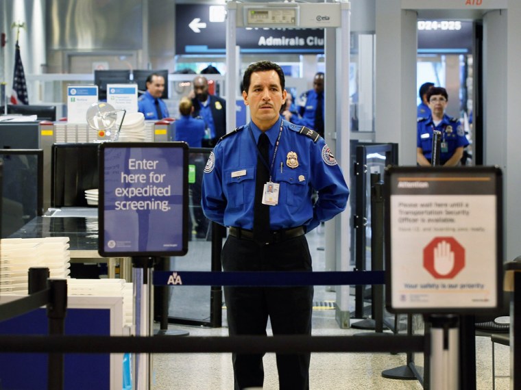 A Transportation Security Administration agent waits for passengers to use the TSA PreCheck lane at Miami International Airport on October 4, 2011, in Miami. The program now is available at 97 airports across the country.