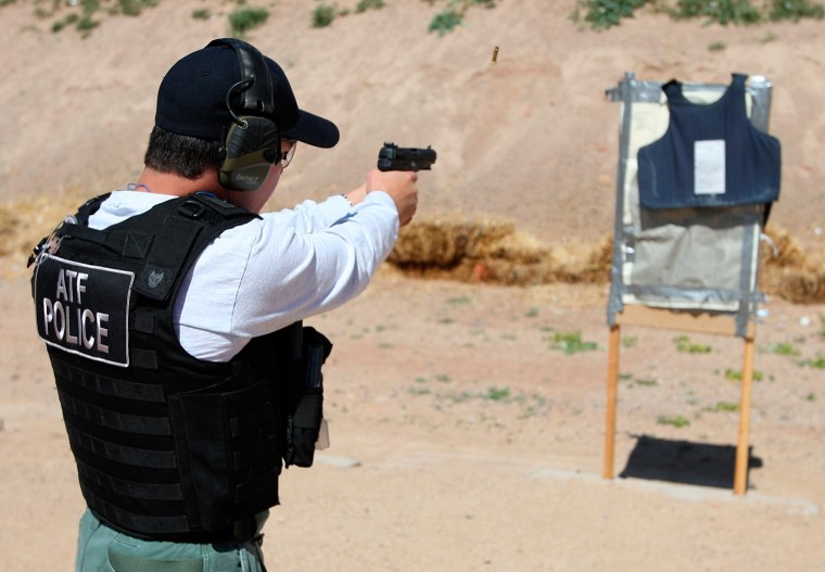 An ATF agent fires rounds from an FN 5.7 Herstal pistol — better known on the streets as a