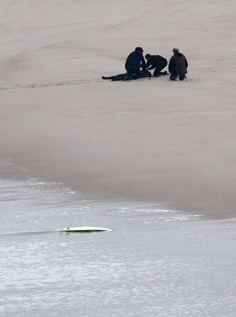 epa03927763 Brazilian professional surfer Maya Gabeira is rescued after a giant wave knocked her unconscious in the surf zone, in Praia do Norte, in N...