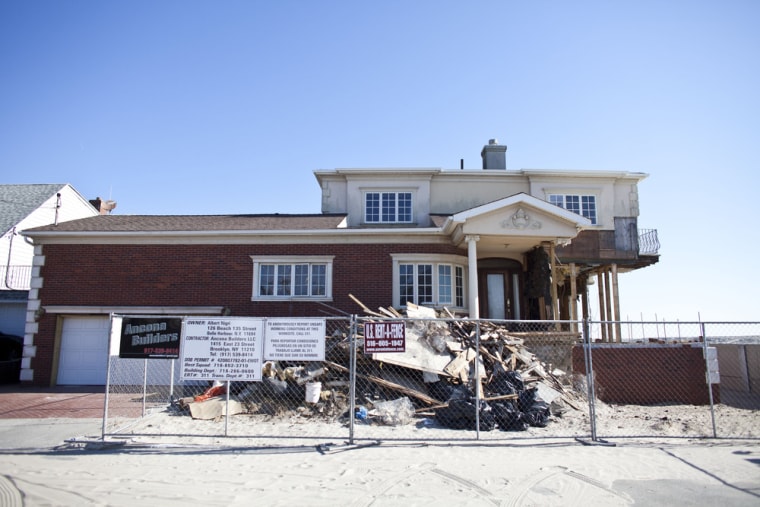 A year later, a house damaged by Superstorm Sandy stands protected by a fence in the Belle Harbor section in the Queens borough of New York City. Hundreds of buildings are still affected, and some people are dealing with health problems because of mold.