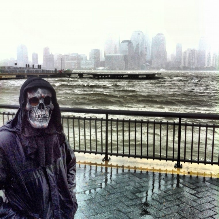 With Superstorm Sandy bearing down on the New Jersey, New York harbor, a figure wearing a Halloween death mask walked through Ed Kashi's frame.
