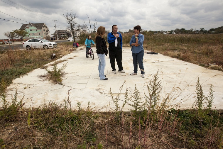 Lori and Joe Argentina survey the remains of their Union Beach, N.J. home, destroyed by Superstorm Sandy. The Argentinas are waiting for a government grant -- their only chance at rebuilding, they say.