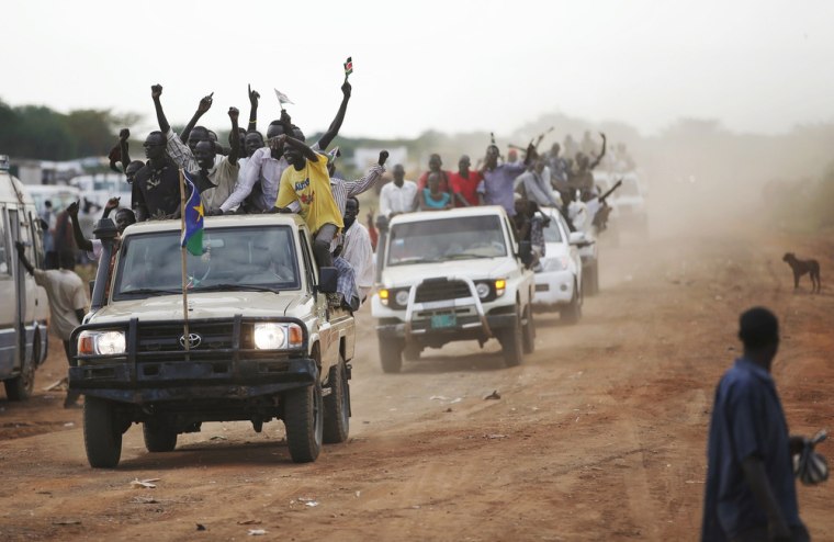 People wave as they arrive in Abyei on Oct. 26. Dinka Ngok people from South Sudan and even from as far away as Australia have returned to take part in the vote.