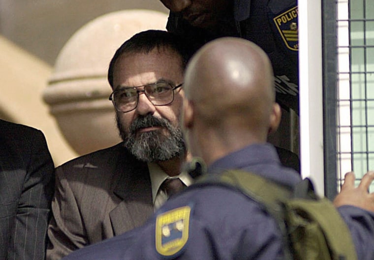 Michael Teshart du Toit leaves Pretoria's courthouse in South Africa, 19 May 2003 under heavy police guard.