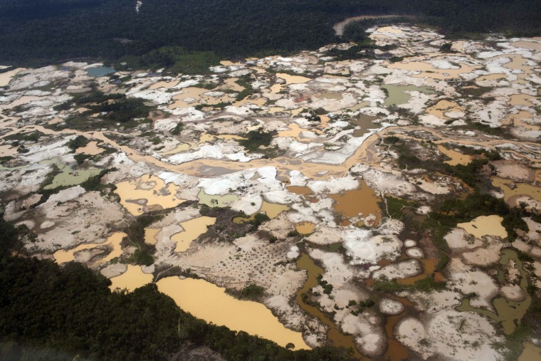 This aerial photo from Sept. 13, 2013 shows tailings produced by informal mining in Peru's Madre de Dios region. A study of mercury contamination from rampant informal gold mining in Peru's Amazon says indigenous people who get their protein mostly from fish are the most affected, particularly their children.