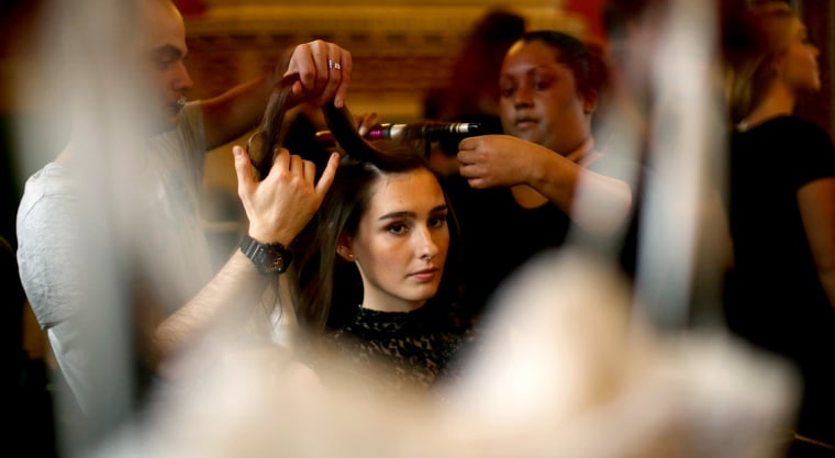 Debutante Jennifer Ward has her hair styled for the Queen Charlotte's Ball at the Royal Courts of Justice on Oct. 26, 2013 in London.
