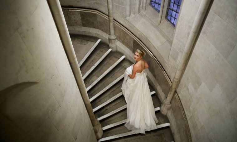 Debutante Eloise Knight, age 17, makes her way through the Royal Courts of Justice during the Queen Charlotte's Ball on Oct. 26, 2013.