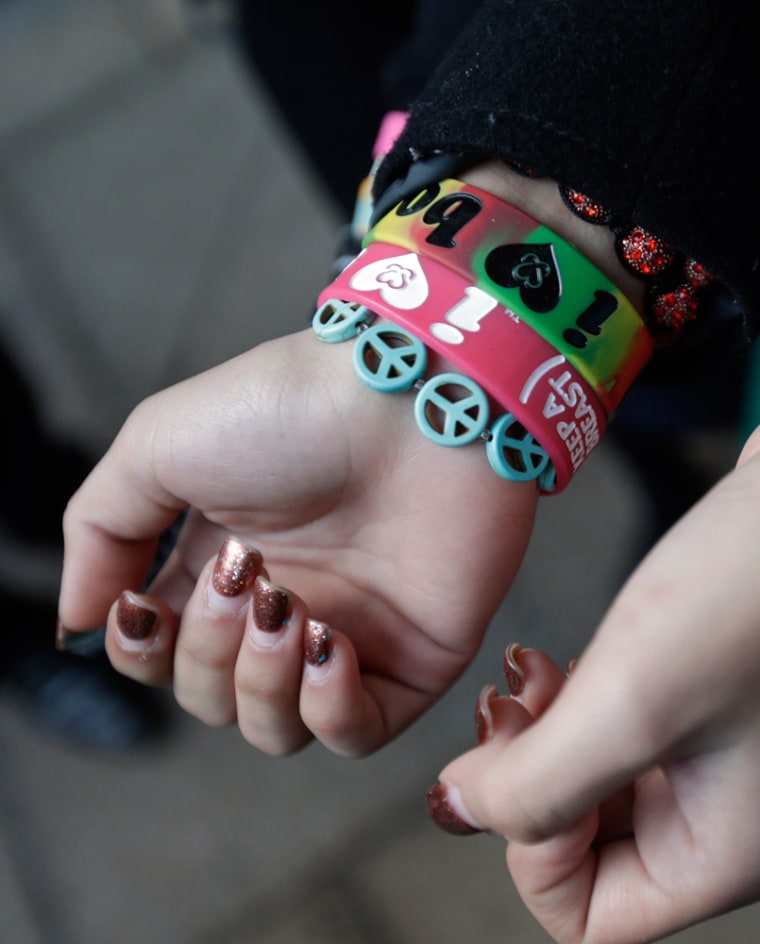 Brianna Hawk, 15, left, and Kayla Martinez, 14, display their bracelets for photographers outside the U.S. Courthouse in Philadelphia on Feb. 20.