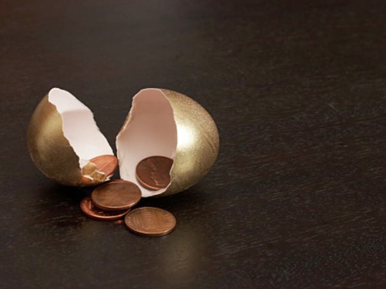 Cracked golden egg containing pennies