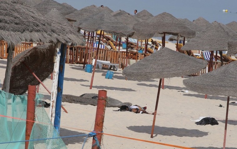 The corpse of a suicide bomber, who blew himself up without any casualties, lies on a beach near the tourist resort of Sousse.