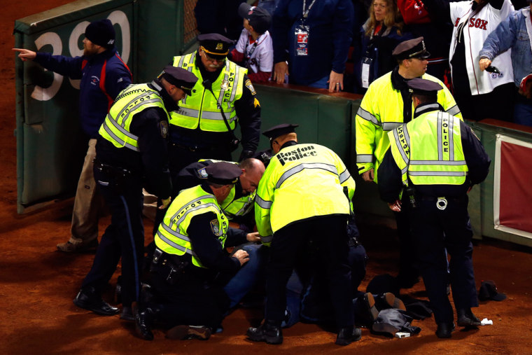 Police subdue a fan after the Red Sox won Game 6.