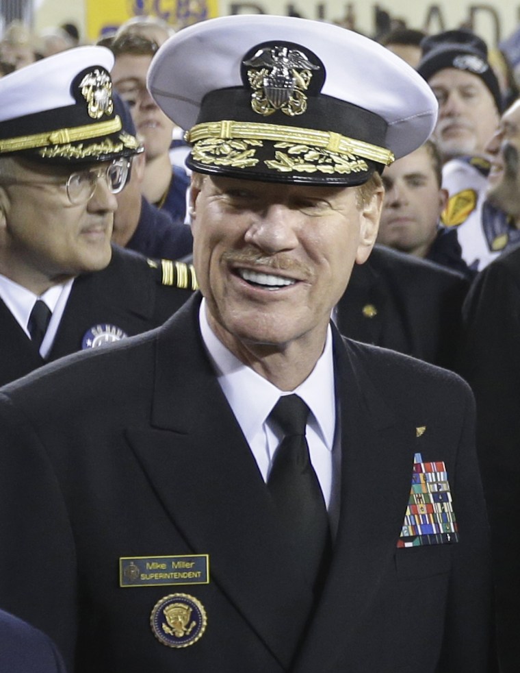 Superintendent of the United States Naval Academy, Vice Admiral Michael H. Miller, poses for photographs after Navy beat Army in an NCAA college football game in 2012.