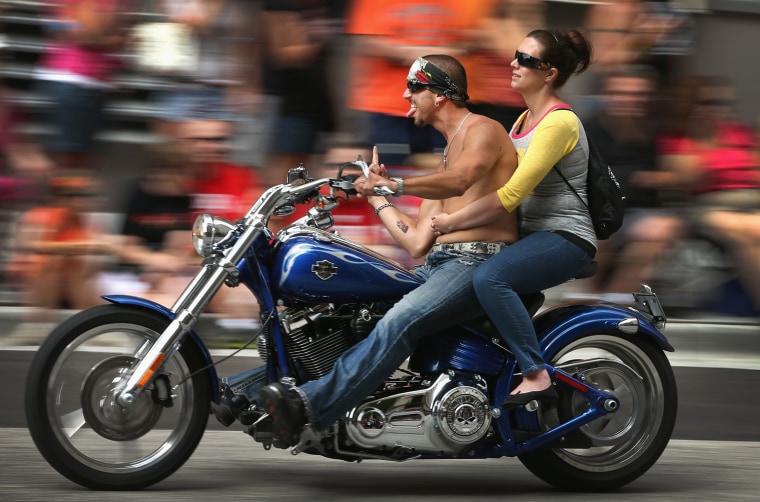 Motorcycle enthusiasts ride their bikes in a parade through downtown to celebrate Harley-Davidson's 110th anniversary on August 31, 2013 in Milwaukee, Wis.