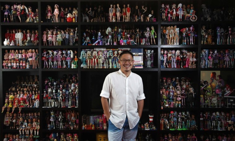 Barbie collector Jian Yang poses with part of his collection at his home in Singapore September 2.