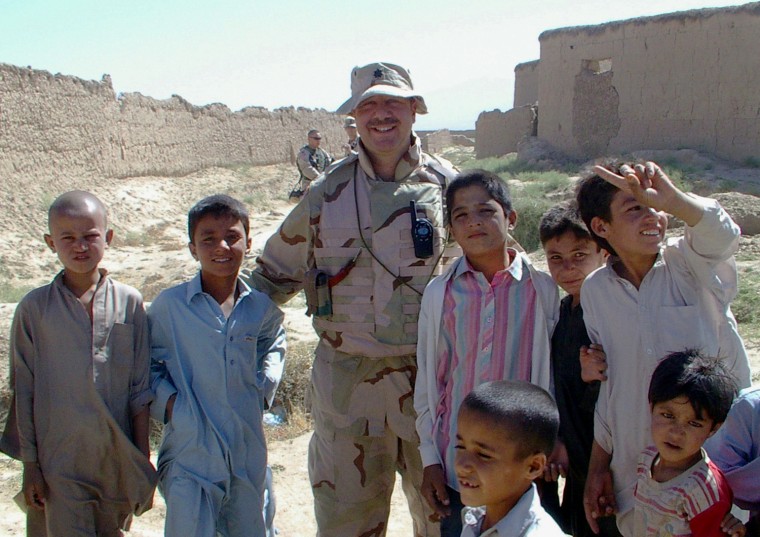Army Reserve Aviation Specialist, Lt. Col. Chuck Schlom, pictured here on a Provincial Reconstruction Team mission in Afghanistan, was deployed in 2005. When his employer found out, he was fired.