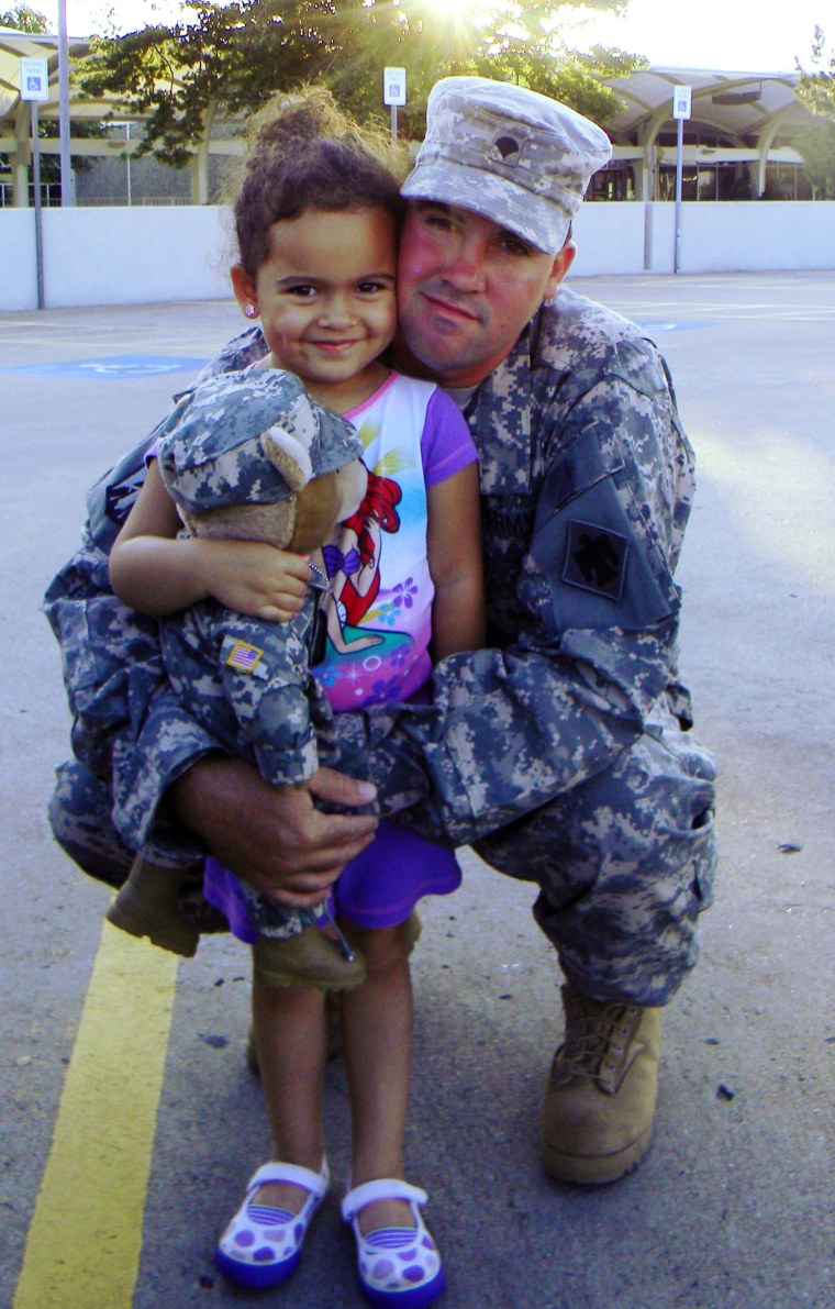 FILE - This July 21, 2013 file photo provided by Shannon Jones, attorney for biological father Dusten Brown, shows Brown with his daughter, Veronica.