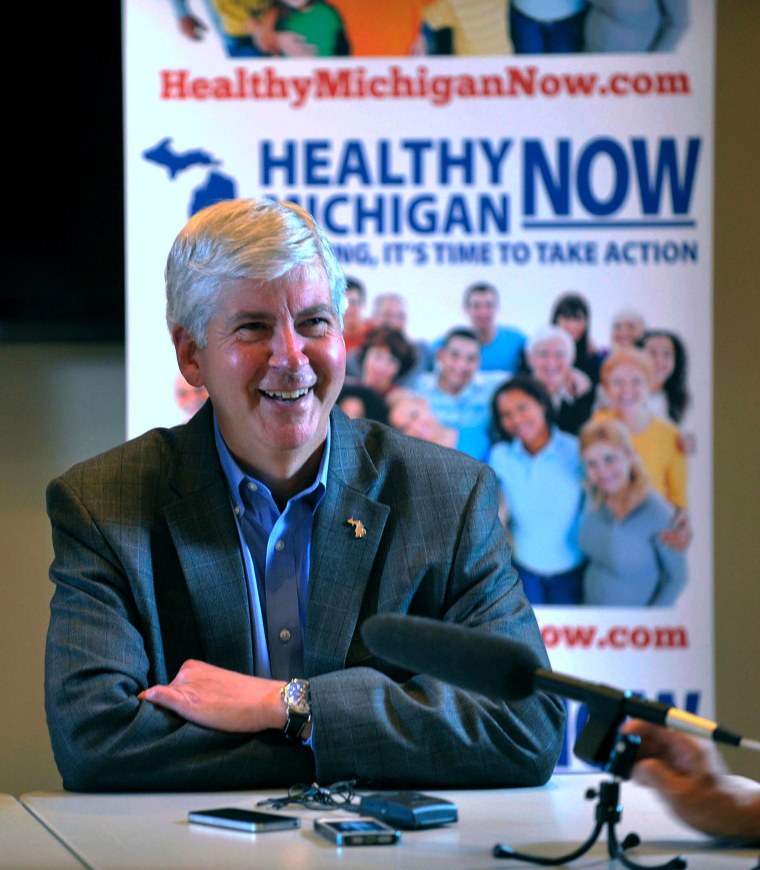 Michigan Gov. Rick Snyder talks to the media after the Michigan House of Representatives passed the Medicaid expansion bill Tuesday, Sept. 3, 2013 in the Capitol building in Lansing.