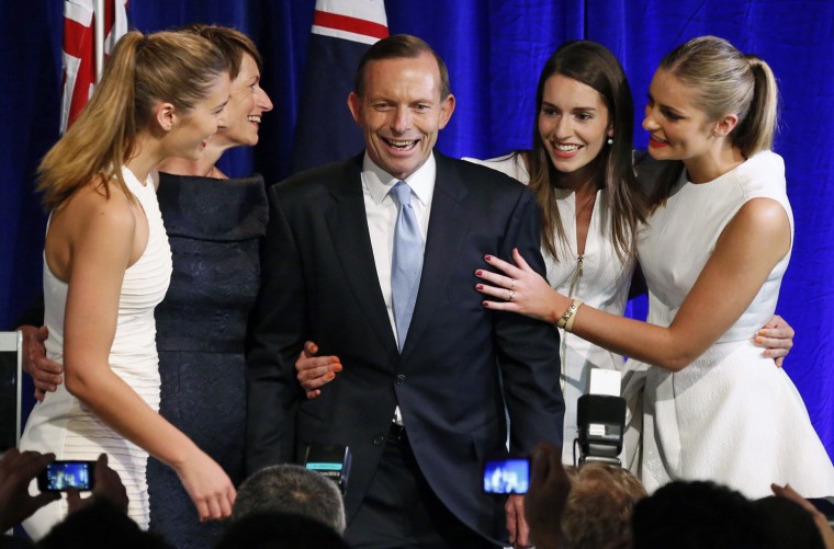 Australia's conservative leader Tony Abbott stands with his wife Margaret and daughters as he claimed victory in Australia's federal election in Sydney on Saturday.