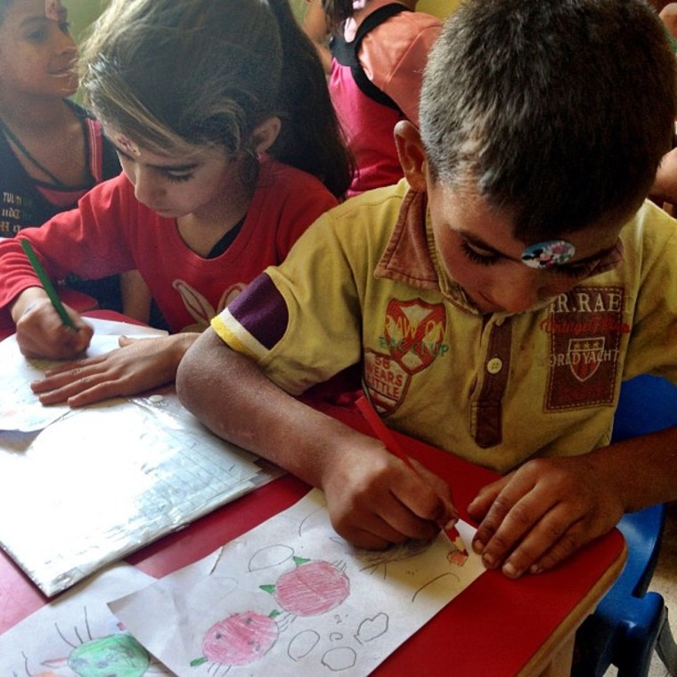 Syrian refugee children are taught to use art to express there feelings in a class taught by a local NGO in a makeshift refugee camp in Lebanon.