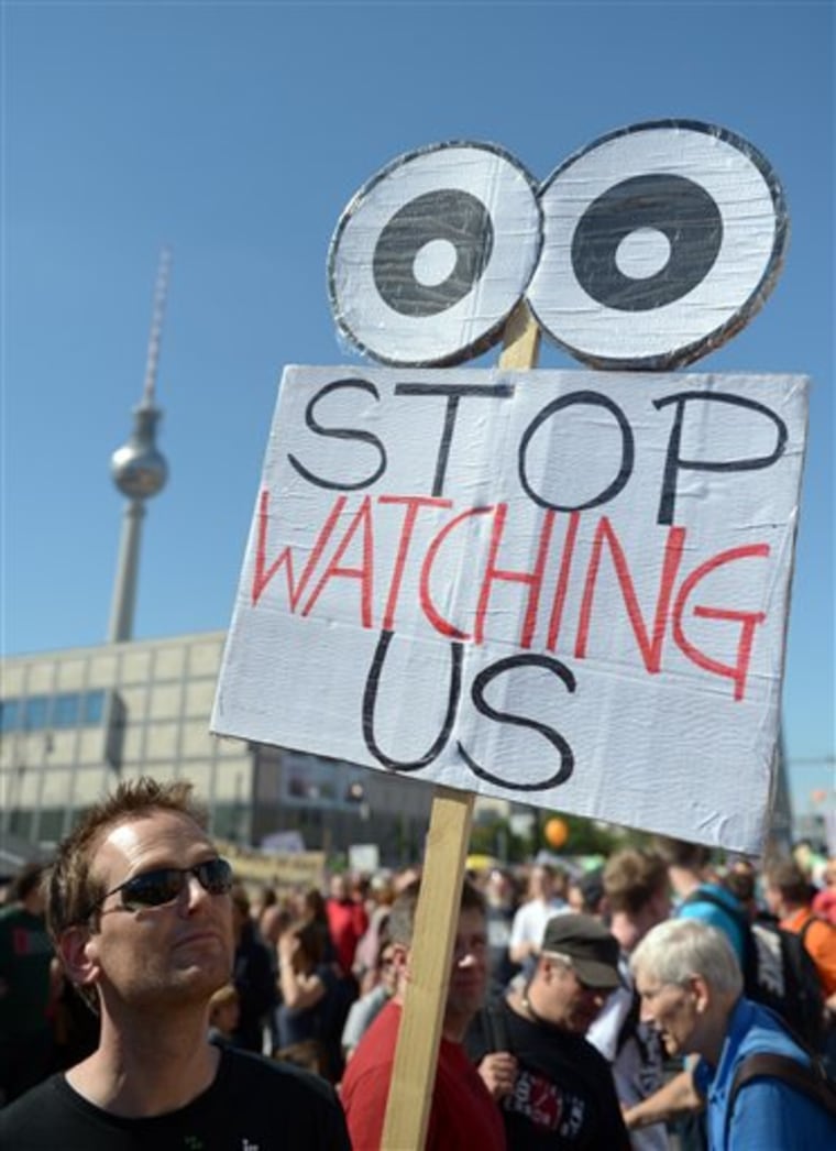 In this picture taken Sept. 7, 2013, acitivists protest with posters during the demonstration in Berlin, Germany. German news weekly Der Spiegel r...