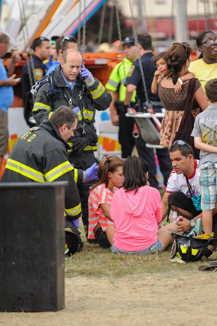 Firefighters attend to injured children Sunday at the Norwalk Oyster Festival in Connecticut.