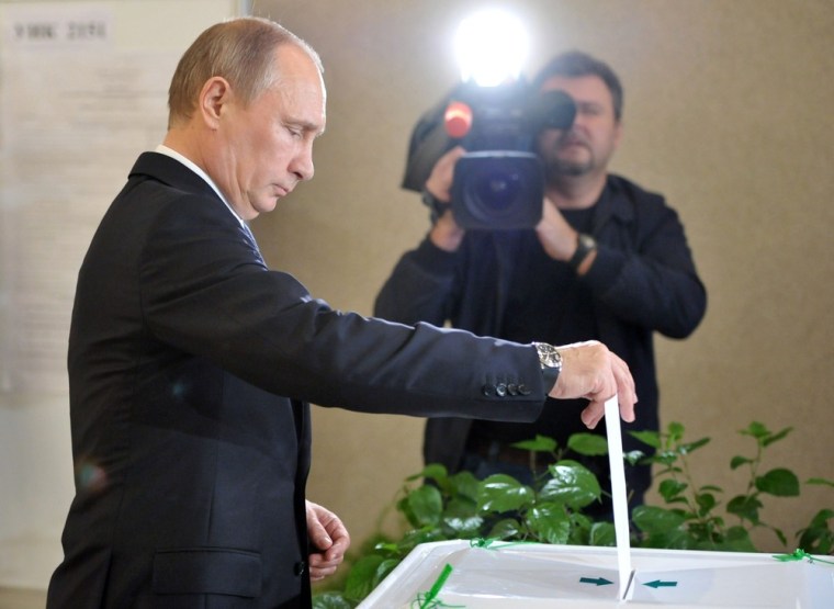 Russia's President Vladimir Putin votes at a polling station in Moscow on Sunday.