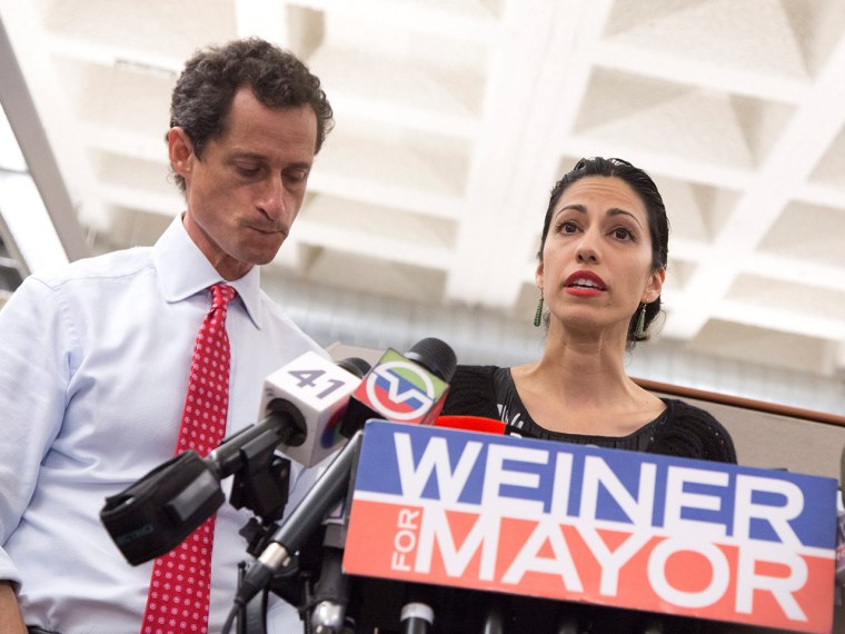 epa03798937 New York City mayoral candidate Anthony Weiner (L) speaks to reporters while standing with his wife Huma Abedin (R) during a press confere...