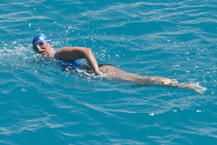 U.S. long-distance swimmer Diana Nyad, positioned about more than two miles off Key West, Florida, swims towards the completion of her 53-hour swim from Cuba to the Florida Keys in this September 2 handout photo.