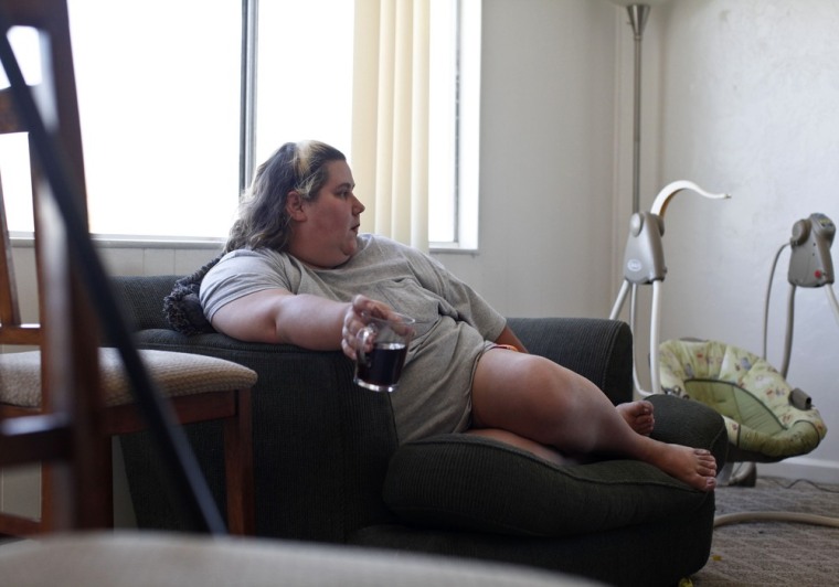 Nicole Eason sits inside her Tucson, Ariz., home on May 7, 2013. Eason has taken in more than a half-dozen children, many from failed international adoptions, during the past decade.