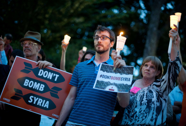 People protest against a US military intervention in Syria in front of the Cannon House Office Building near the US Capitol in Washington on Monday.