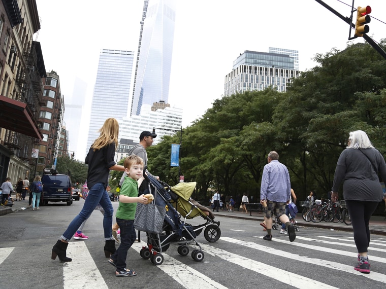 Jacoba and Wilson Urist pass the Freedom Tower while running errands in their neighborhood.