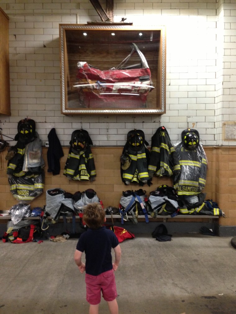 Wilson Urist at his local fire station, where part of the fire chief's charred truck from 9/11 hangs on the wall.