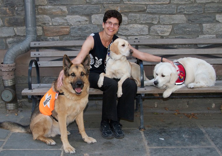 Image: \"Hero Dogs of 9/11\"; Dr. Cynthia Otto 10 years later with dogs.