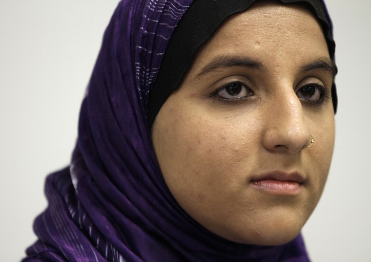Hani Khan, a former stockroom worker for Abercrombie & Fitch Co. who was fired for refusing to remove her Muslim headscarf, listens to a question duri...