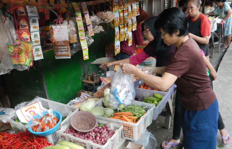 Indonesians buy staple foods as vendors mind their stalls at a traditional street market in Jakarta on Jan. 3.