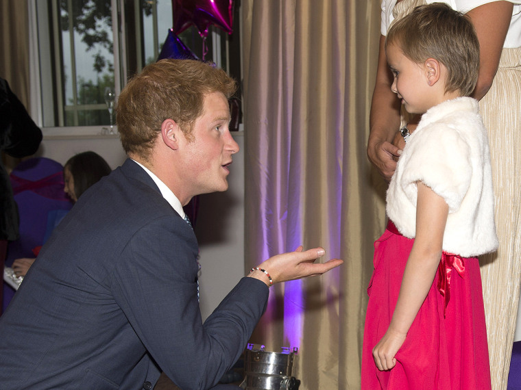 Britain's Prince Harry (L) talks with Maidison Kirk (R), 6, as he attends the annual WellChild awards in central London on September 11, 2013. Prince ...