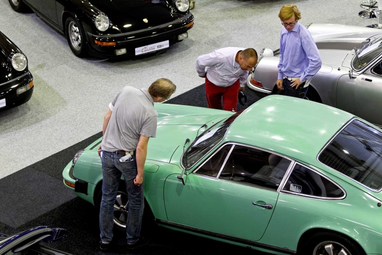 Visitors view a classic Porsche 911 sportscar at the Porsche Fest in the Autotron in Rosmalen, The Netherlands, 07 September 2013. The eve...