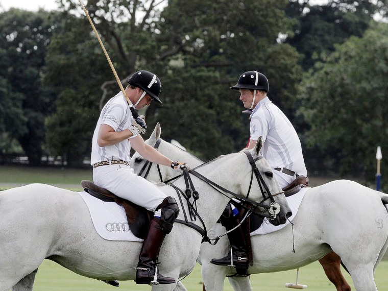 The sport of kings: Prince Harry chats with Prince William at a charity polo match at Coworth Park, England August 3.