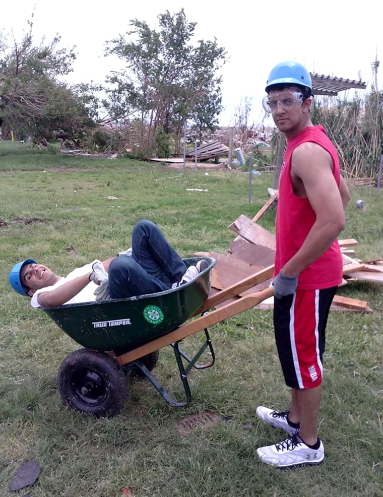 ALM members Salman Ausaf (left) and Shariq Mohammad have some fun during a break from tornado cleanup efforts in Moore, Okla., earlier this year.