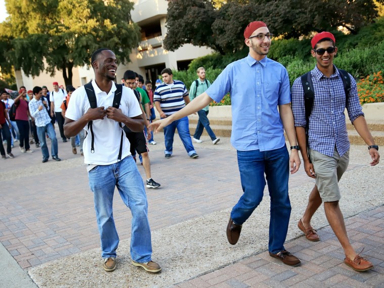 Ali Mahmoud (center), president and founder of Alif Laam Meem Muslim fraternity, walks with members Ibrahim Eke (left) and Yousuf Hassan on the campus of University of Texas at Dallas.