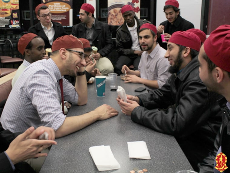 Members of the Muslim fraternity Alif Laam Meem, or Alpha Lambda Mu, engage with a speaker during one of their meetings.